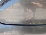 a reflection of a man in a car ' s rear view mirror