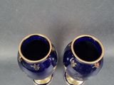 pair of blue and gold vases on a grey background