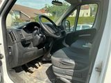 a white van with a black seat and steering wheel