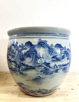 un vase bleu et blanc posé sur une table en bois