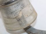 a metal object that is sitting on a white surface