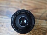 a black camera lens sitting on a wooden table