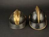 two helmets that are sitting side by side on a black surface