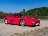 a red sports car parked on the side of the road