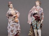 three porcelain figurines of a man and a woman with a child