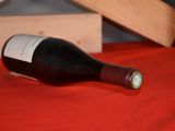 a bottle of wine sitting on a table next to a wooden box