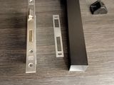 a black door handle and a metal latch on a wooden table