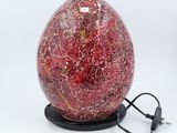 red cracky glass lamp with a black base and a cord