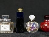 three small bottles of perfume sitting next to each other on a table