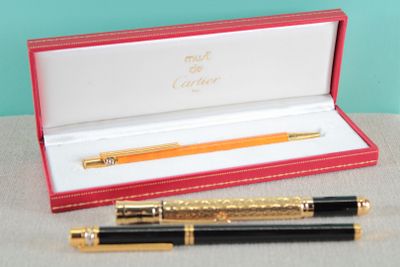 a pen and a ballpoint pen in a red box
