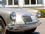 a silver car that is parked in front of a building