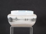 a glass vase that is sitting on a stand