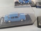 three toy cars that are sitting in a display case