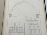 an open book with a drawing of a circular structure on it