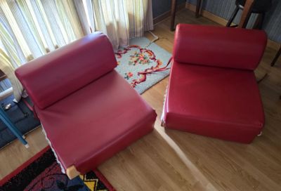 a red chair and a red chair in a living room