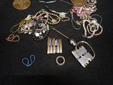 a pile of assorted jewelry on a black table