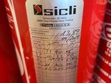 a red fire extinguisor sitting on a shelf