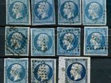 six different blue and white stamps with portraits of people on them