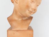marble bust of a young boy on a marble base