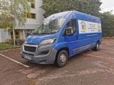 a blue van that is parked in a parking lot