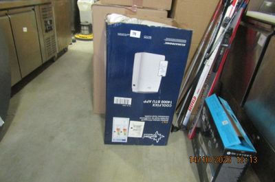a box that is sitting on the floor next to a refrigerator