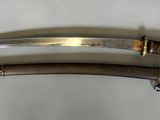 pair of silver and gold - plated swords on a white background