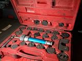 a red tool case with tools in it on a table