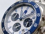 rolex watch with blue bezel and white dial on a silver bracelet