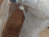 a white horse wrapped in plastic and sitting on the floor