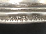 a close up of a silver plate with writing on it