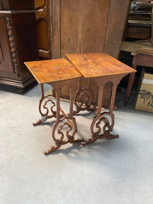 two tables that are sitting on the floor in a room