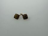 a pair of earrings on a white surface