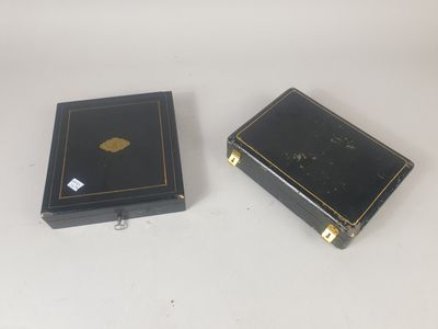 pair of black and gold boxes on a white surface