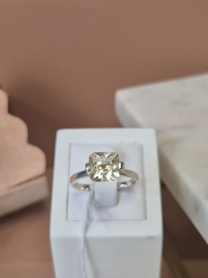a white box with a ring inside of it on a table