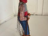 a figurine of a man with a red hat and scarf