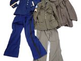 three military uniforms are lined up on a white surface