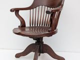 a wooden chair that is sitting on a white surface