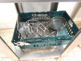 a basket with a bunch of cooking utensils inside of it