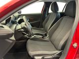 the interior of a red car with two seats and a steering wheel