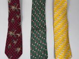 three ties are lined up in a row on a white surface