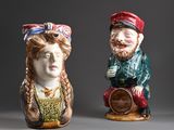 two figurines of a man and a woman sitting next to each other