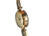 a close up of a wrist watch with a chain around it