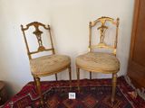 pair of antique chairs with upholstered seats in a room