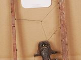 a small sculpture of a man in a cage