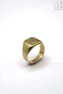 a close up of a gold ring on a white surface
