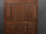 an old wooden chest of drawers against a black backdrop