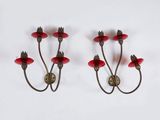 pair of red candle holders on a white background