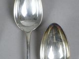 two spoons sitting next to each other on a table