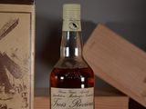 a bottle of liquor sitting on a table next to a box