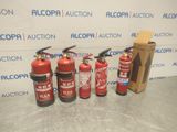 four fire extinguisors are lined up in front of a wall